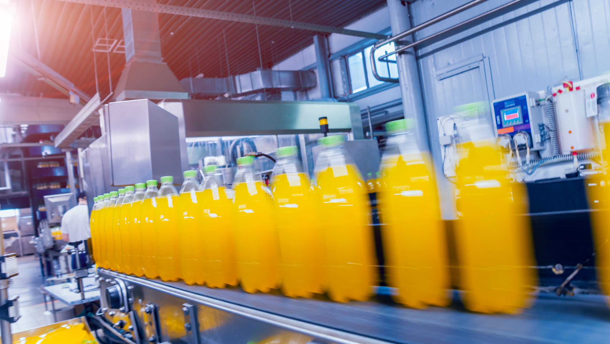 Beverage factory interior. Conveyor with bottles for juice or water